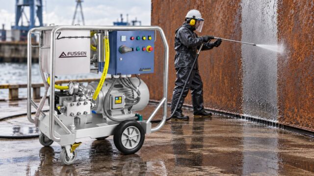 Operator removing rust from a steel wall with a Fussen FDE Series ultra high pressure washer